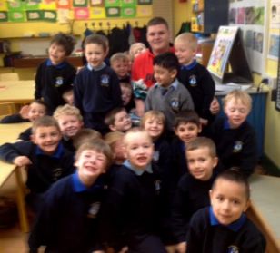 Junior Infants give Ian a present